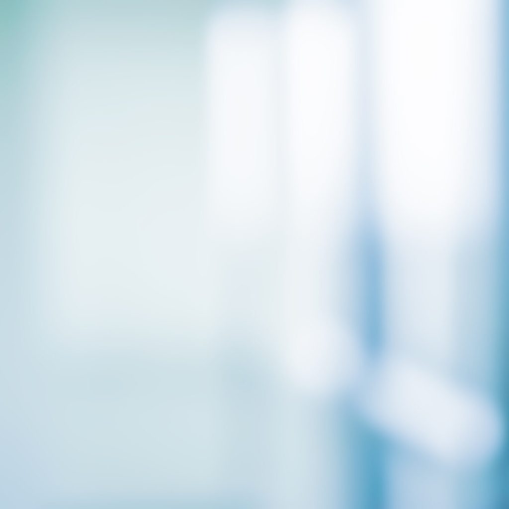 iStock-1066248468 abstract blurred interior of corridor clinic background in blue color , blurry image for presentation ,banner ,ads design concept